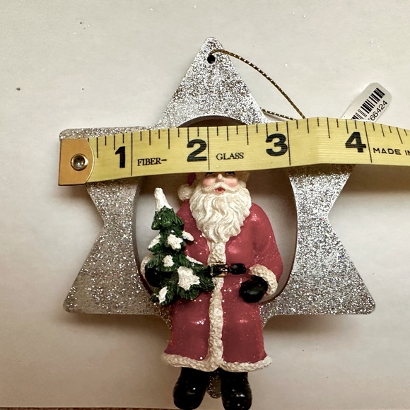 A Glittering Silver Star Christmas Ornament with a jolly Santa holding a Tree - Picture 6 of 6